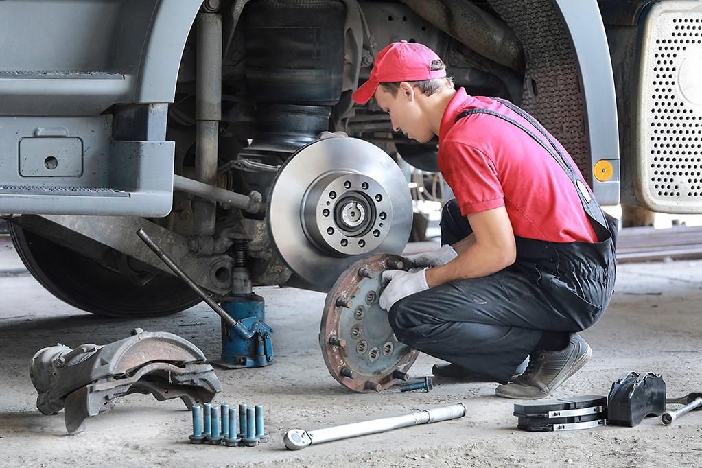 Semi Truck Services That Pay for Themselves (And the Ones That Don't) 1 Mechanic performing detailed brake inspection on semi truck during preventive maintenance service