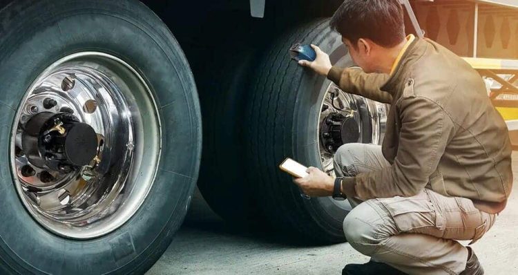 How Often Should Tires Be Rotated? A 5-Step Tire Service Guide 2 Mechanic performing tire service inspection including tread depth check and tire pressure on a truck at Red Rock Garage in St. George Utah