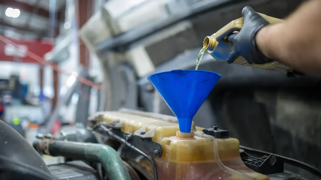 Mechanic changing the oil filter on a semi truck engine during routine maintenance - semi truck repair